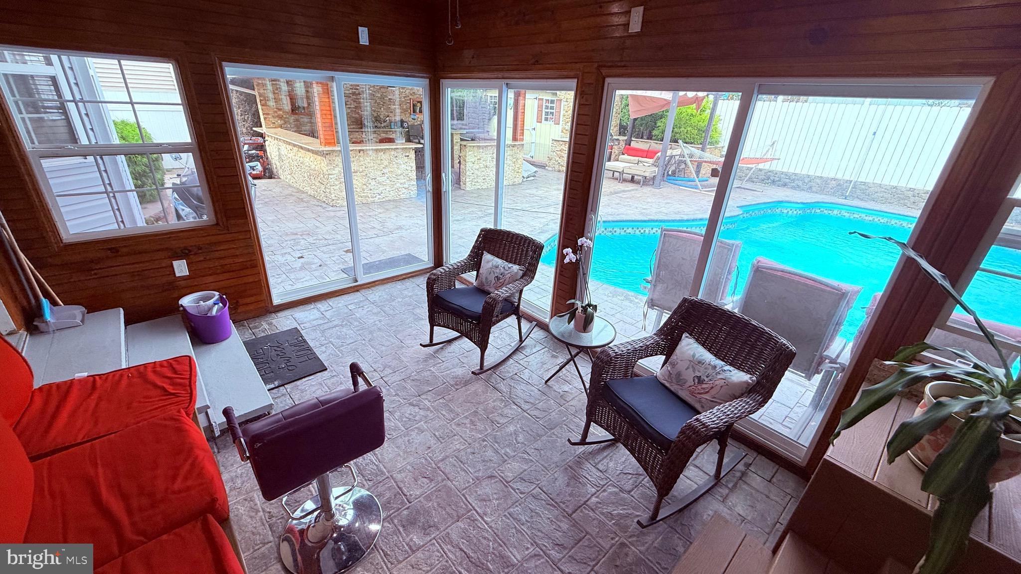 8905 Springview Road Philadelphia, PA 19115 - Photo 48 of 113 a living room with furniture and floor to ceiling windows