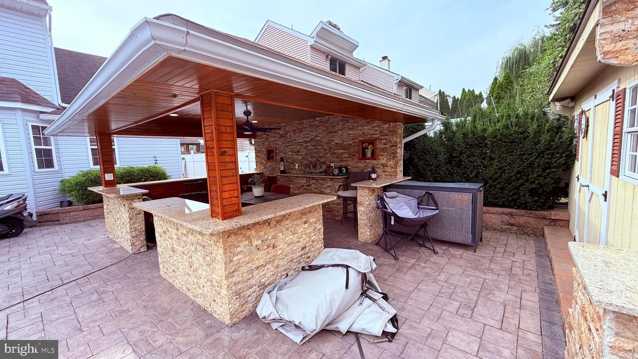 8905 Springview Road Philadelphia, PA 19115 - Photo 61 of 113 a view of a patio with table and chairs potted plants with wooden floor and fence