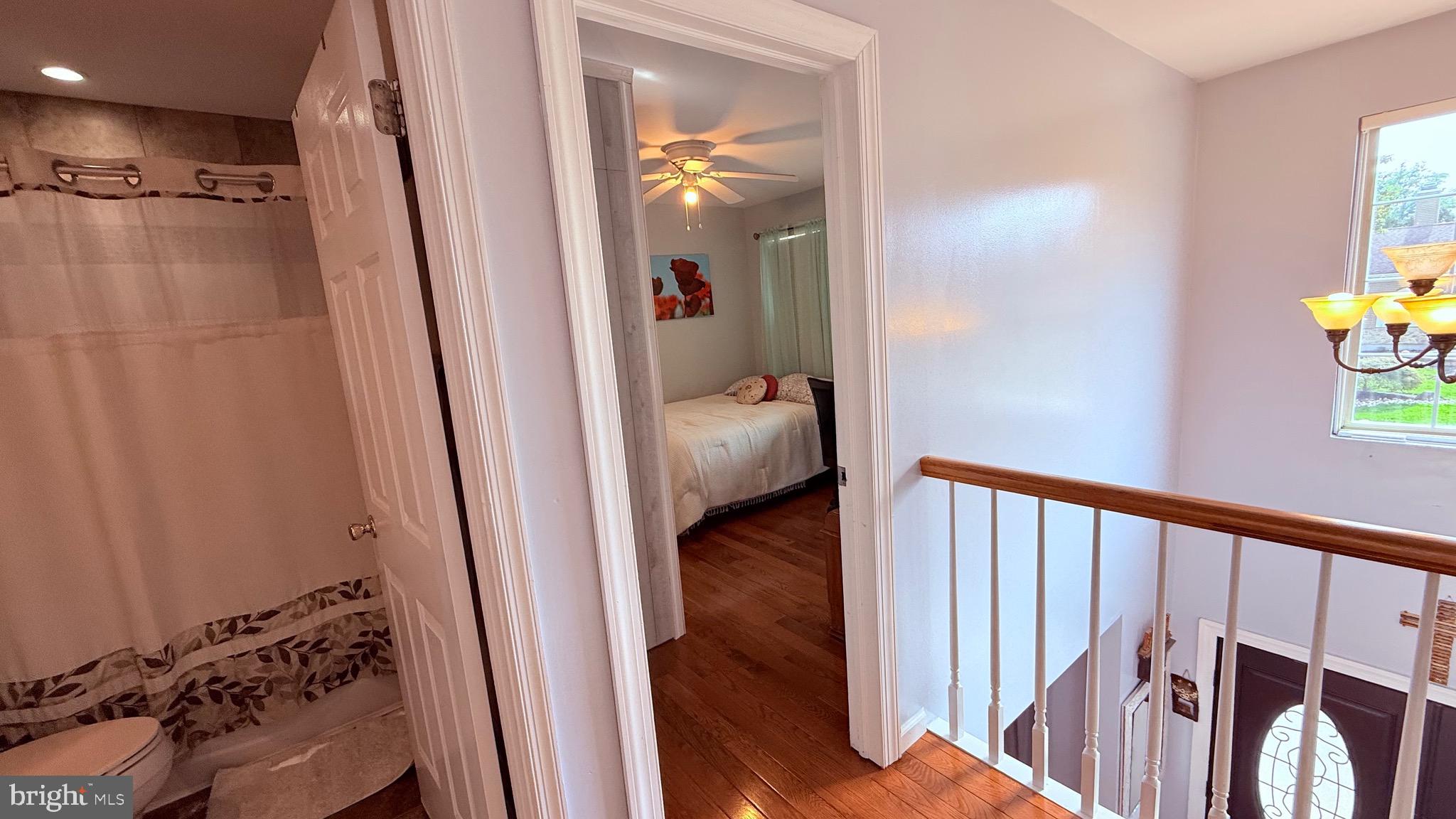 8905 Springview Road Philadelphia, PA 19115 - Photo 86 of 113 a view of a hallway with wooden floor and a bedroom