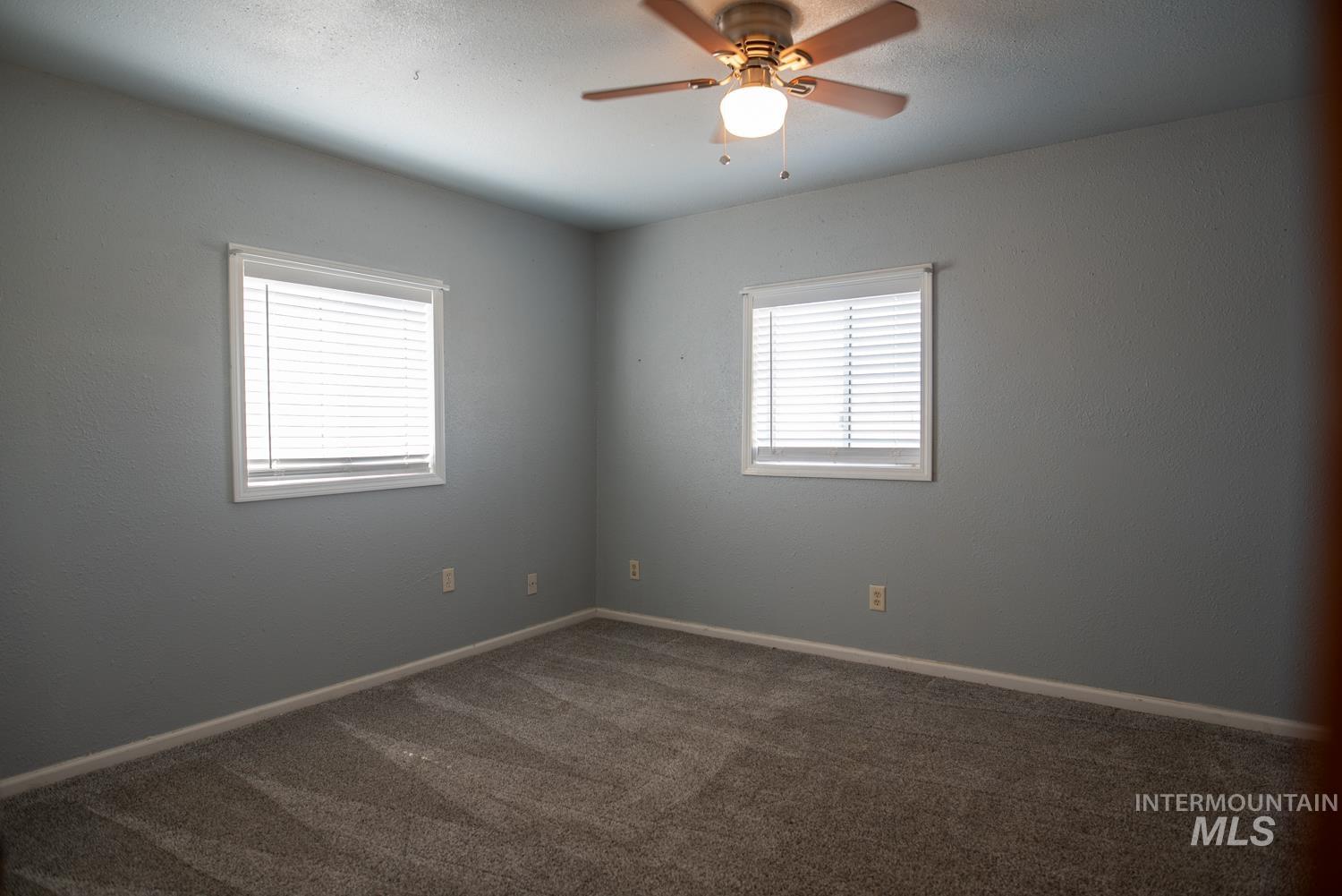 2240 Waite Road Midvale, ID 83645 - Photo 5 of 42 Empty room with carpet floors and a ceiling fan