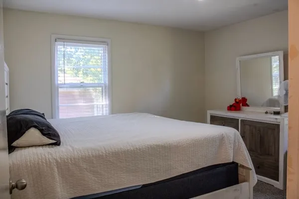 a bedroom with a bed and window