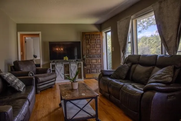 a living room with furniture and a flat screen tv