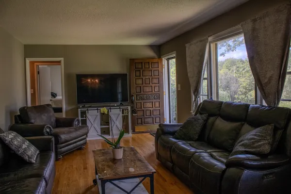 a living room with furniture and a flat screen tv