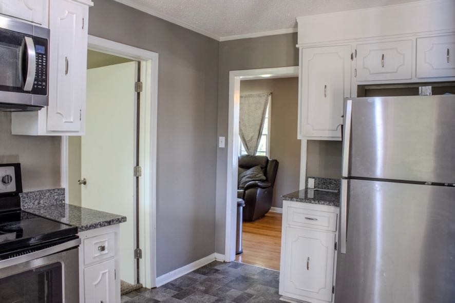 401 South Pawnee Drive Springfield, TN 37172 - Photo 10 of 27 a kitchen with a refrigerator sink stove and cabinets