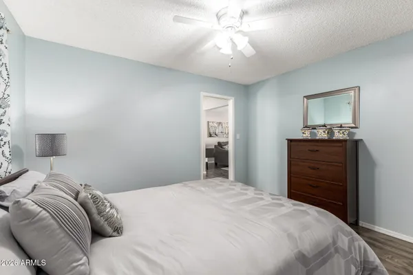 a bedroom with a large bed and a chandelier