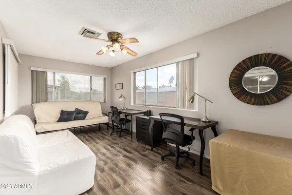 a living room with furniture a table and a large window