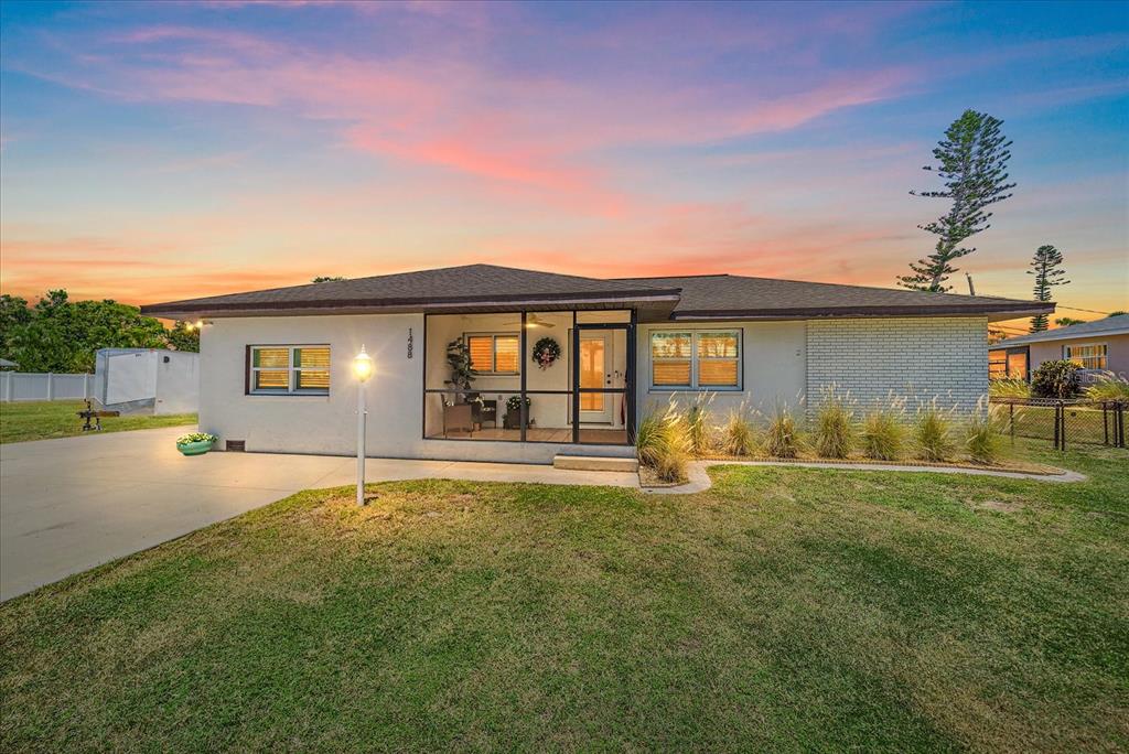 a front view of a house with a garden