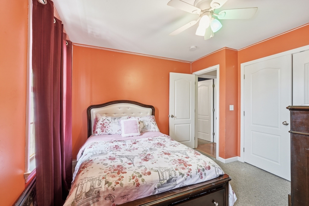 19 Annies Way Springfield, MA 01119 - Photo 25 of 40 a bedroom with a bed and a chandelier