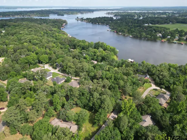 an aerial view of residential houses with outdoor space and river