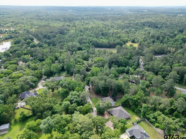 an aerial view of a house with yard