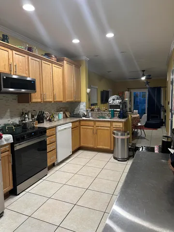 a kitchen with stainless steel appliances granite countertop a sink counter space cabinets and a large window