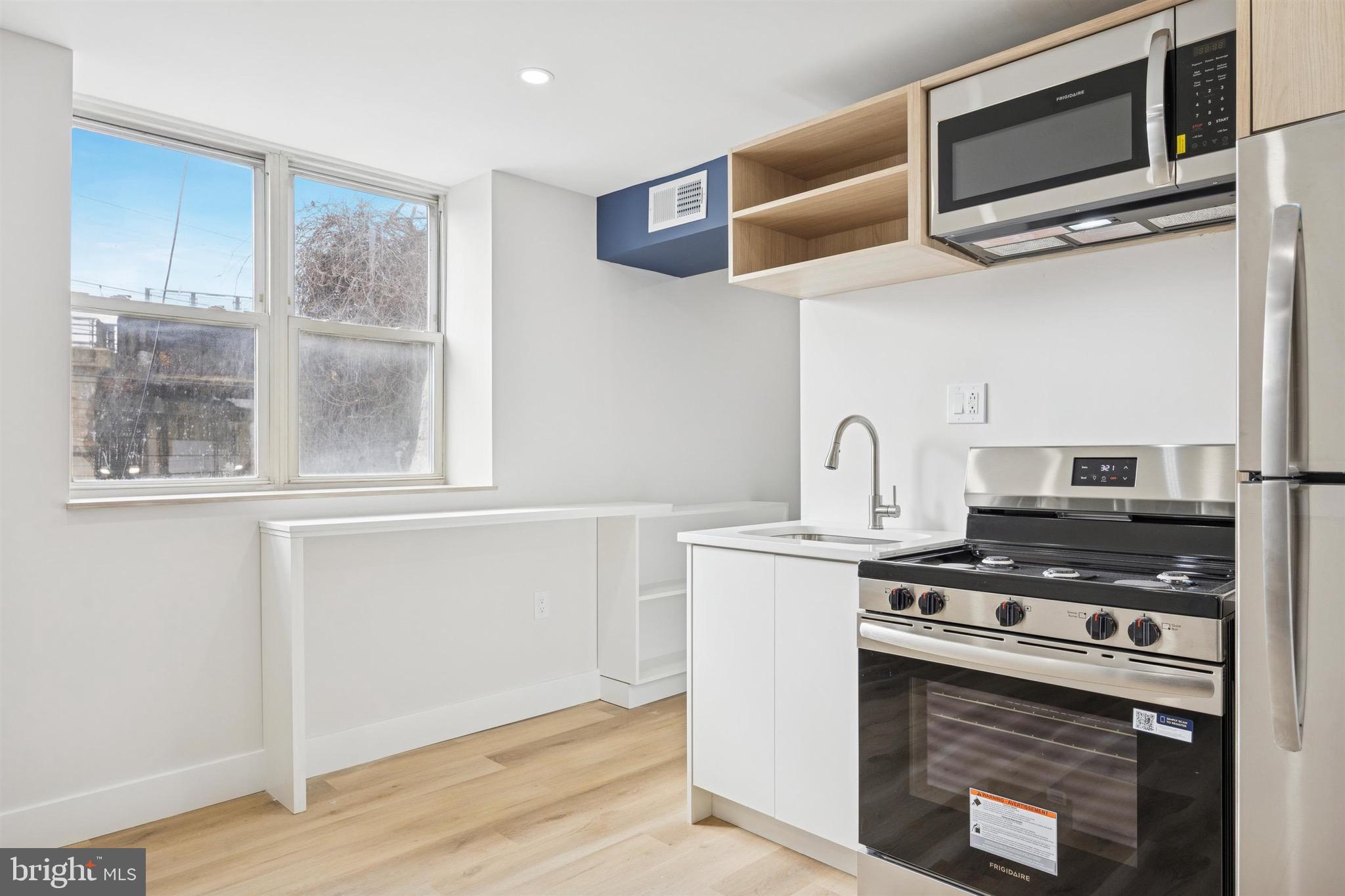 4522 Baker Street, Unit 6 Philadelphia, PA 19127 - Photo 1 of 11 a kitchen with stainless steel appliances granite countertop a stove and a microwave