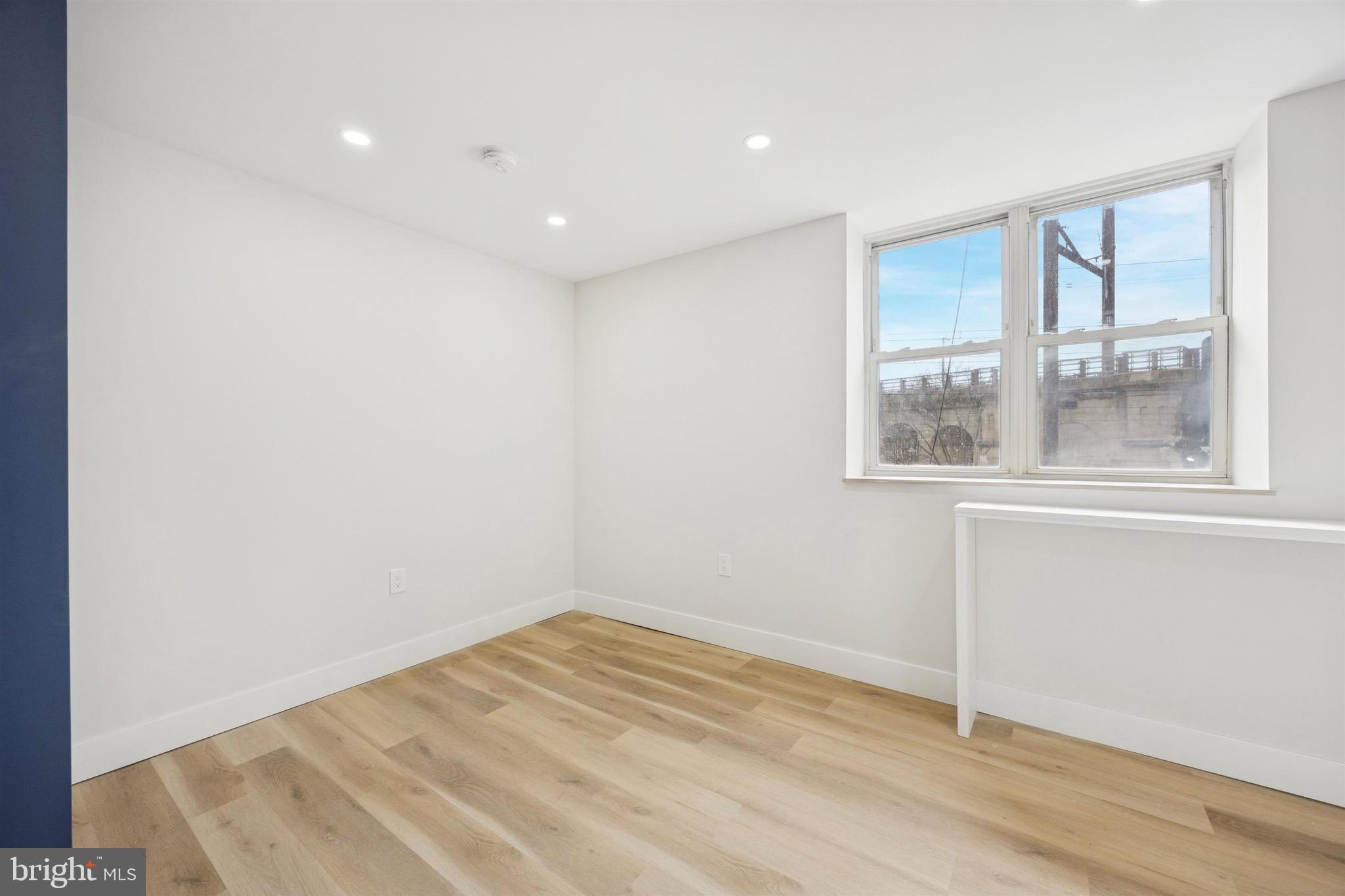 4522 Baker Street, Unit 6 Philadelphia, PA 19127 - Photo 3 of 11 a view of empty room with wooden floor and fan