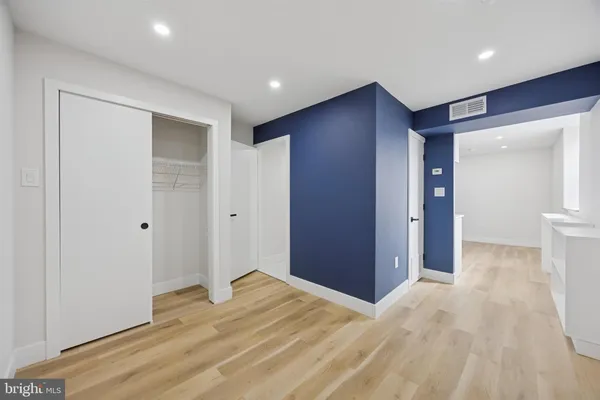 a view of hallway with wooden floor