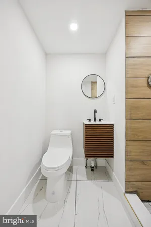 a bathroom with a toilet a sink and a mirror