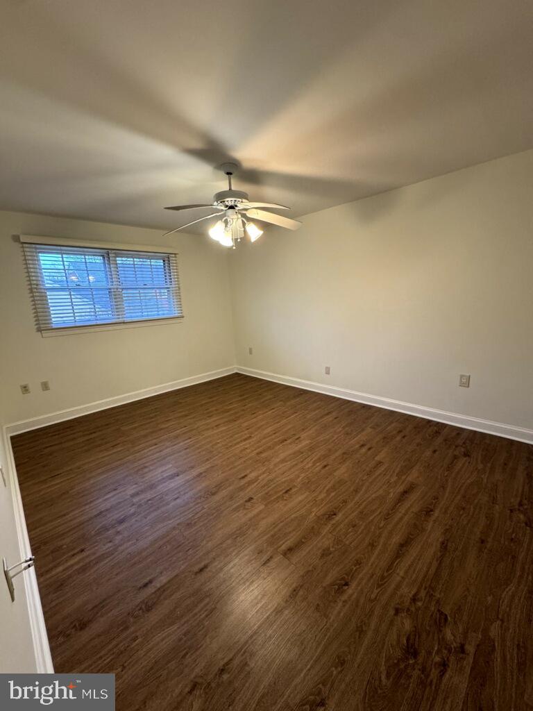 109 Yardley Commons Yardley, PA 19067 - Photo 13 of 19 a view of an empty room with wooden floor and a ceiling fan
