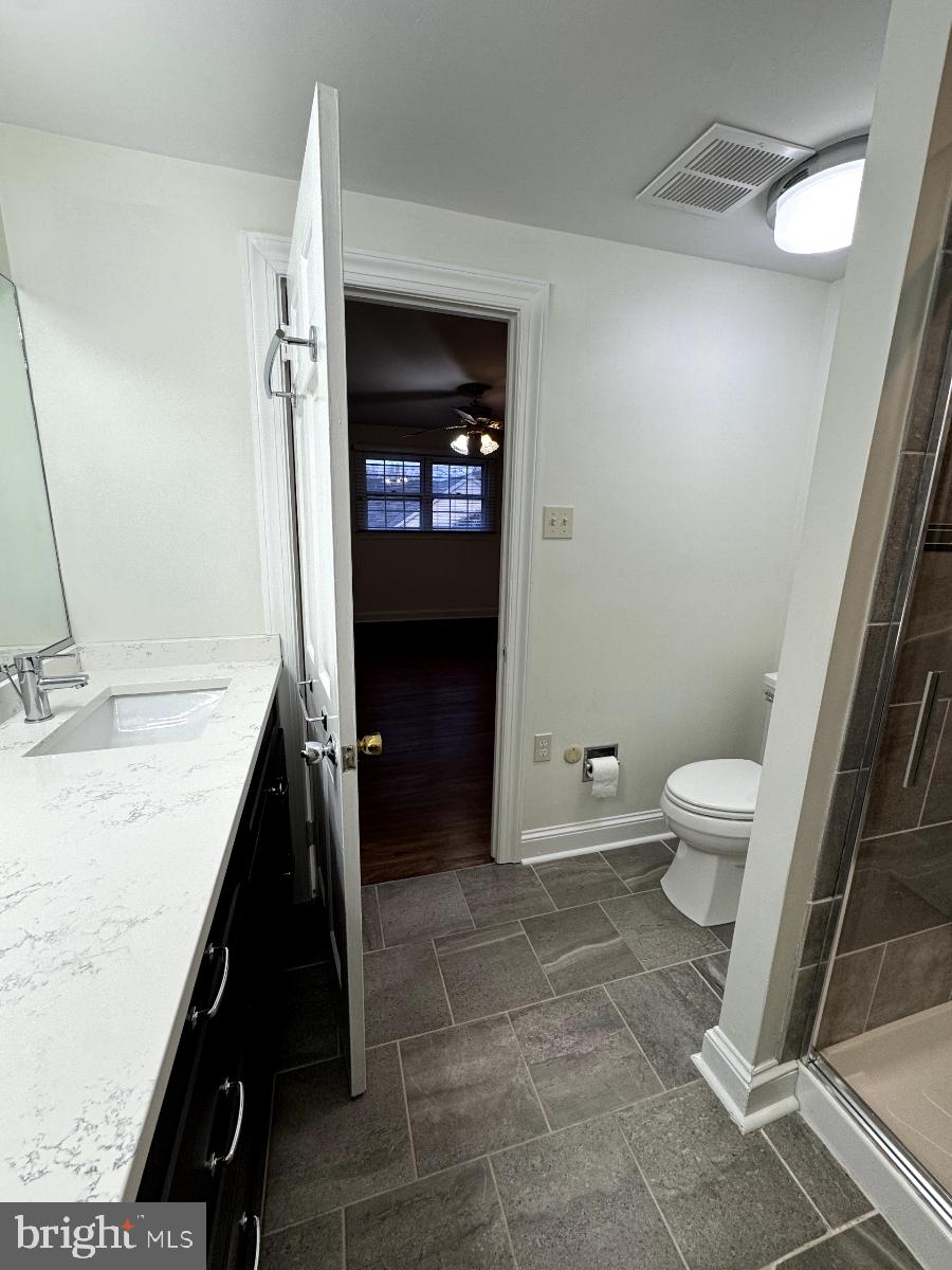 109 Yardley Commons Yardley, PA 19067 - Photo 16 of 19 a bathroom with a granite countertop sink a toilet and a mirror