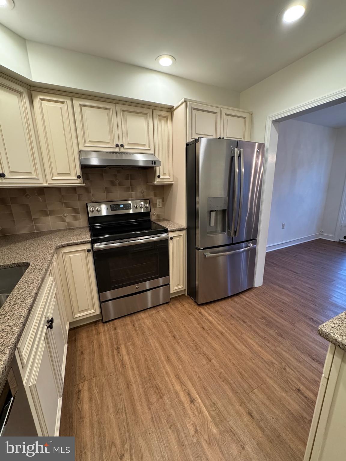 109 Yardley Commons Yardley, PA 19067 - Photo 9 of 19 a kitchen with granite countertop a refrigerator stove and microwave