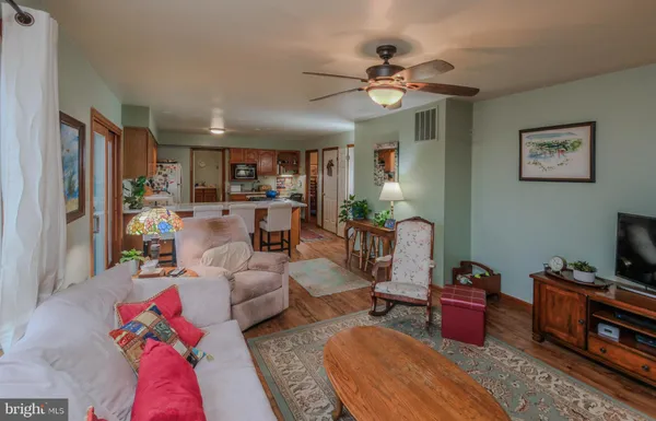 a living room with furniture and a wooden floor