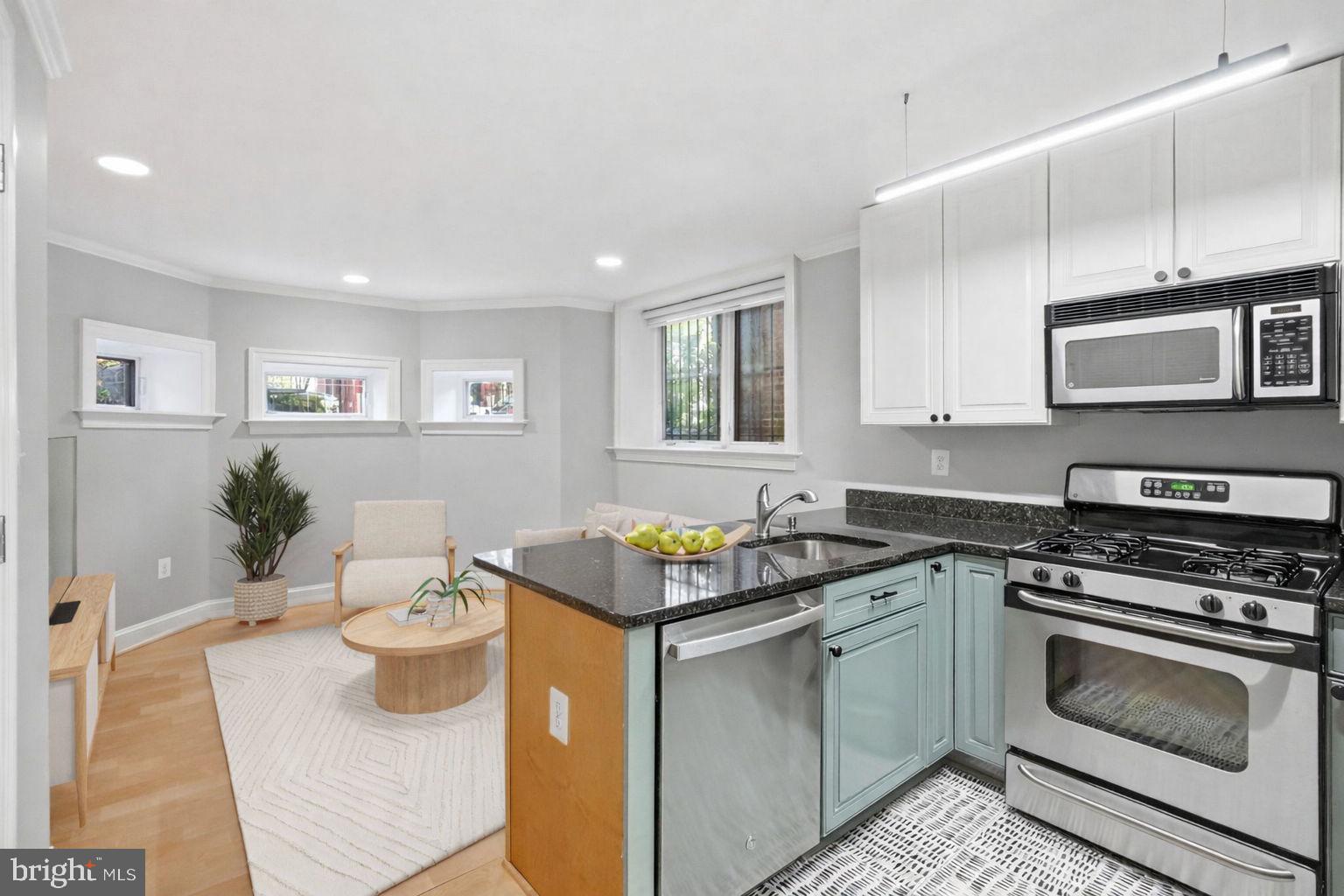 1740 18th Street Northwest, Unit T2 Washington, DC 20009 - Photo 12 of 12 a kitchen with stainless steel appliances granite countertop a stove a sink and a microwave