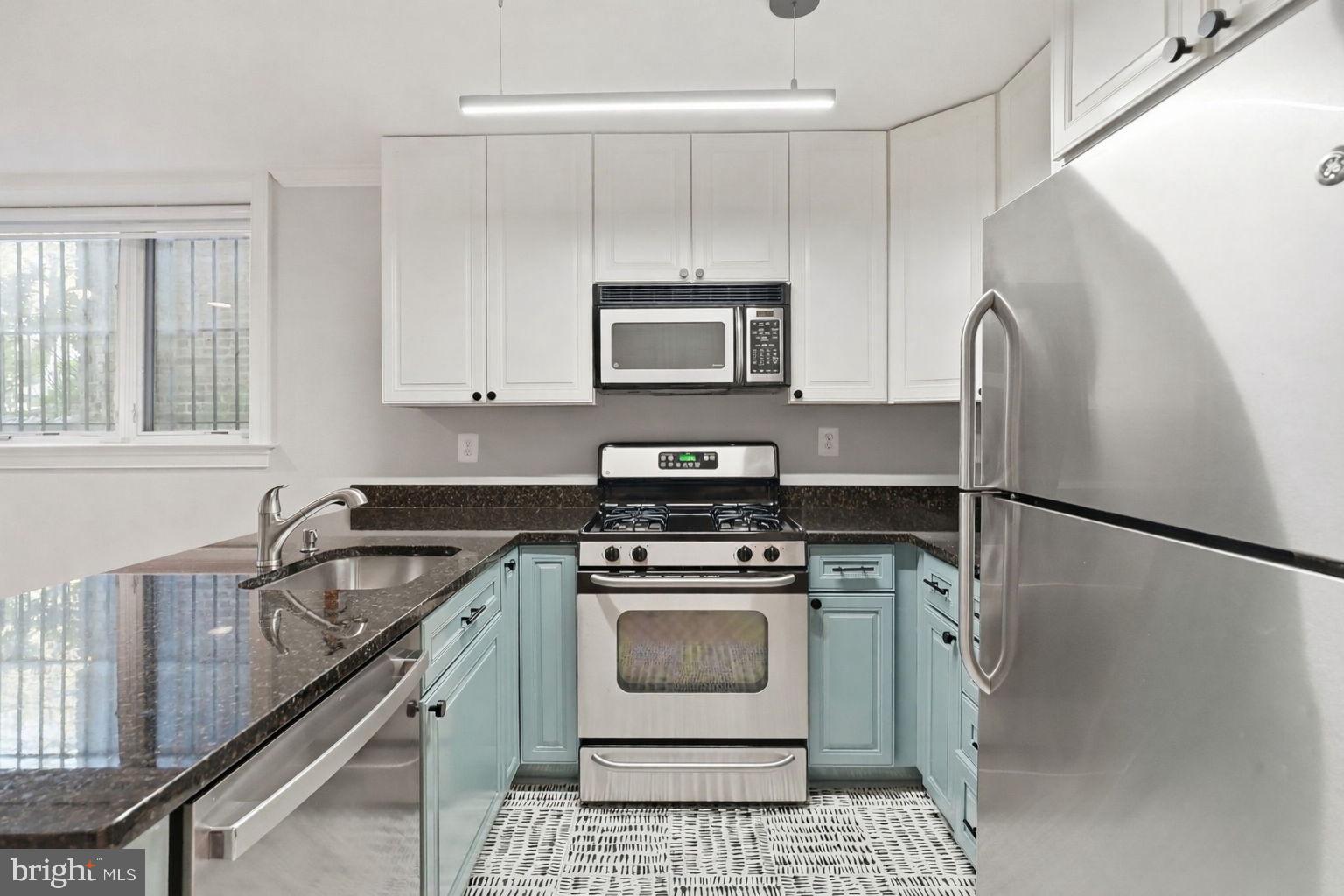 1740 18th Street Northwest, Unit T2 Washington, DC 20009 - Photo 3 of 12 a kitchen with granite countertop a stove sink and refrigerator