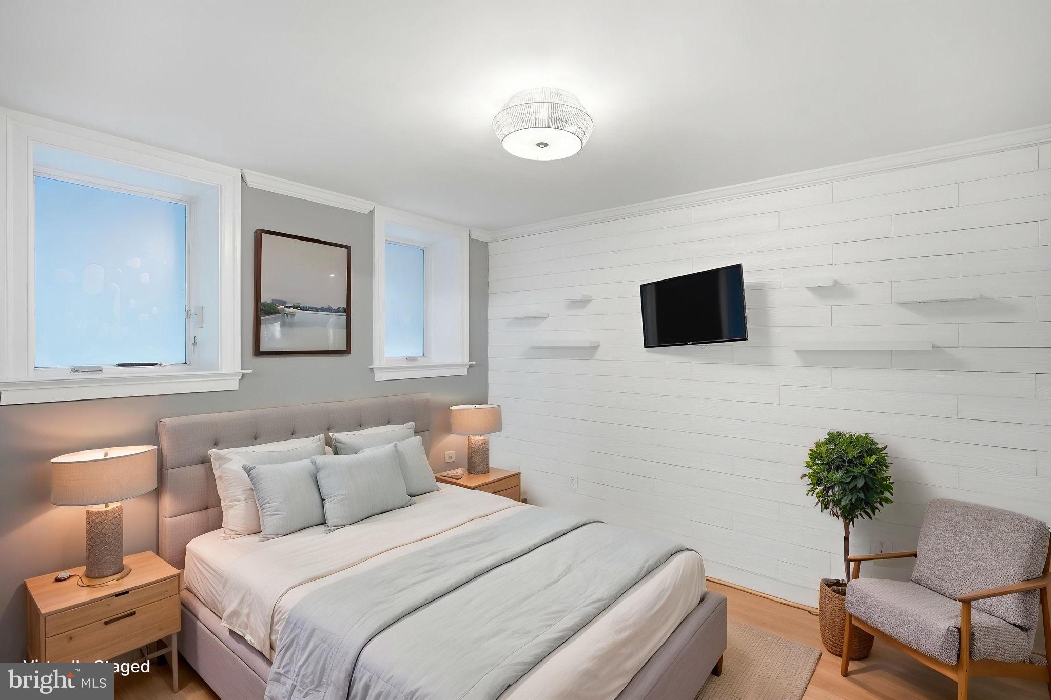 1740 18th Street Northwest, Unit T2 Washington, DC 20009 - Photo 4 of 12 a bedroom with a bed and a potted plant