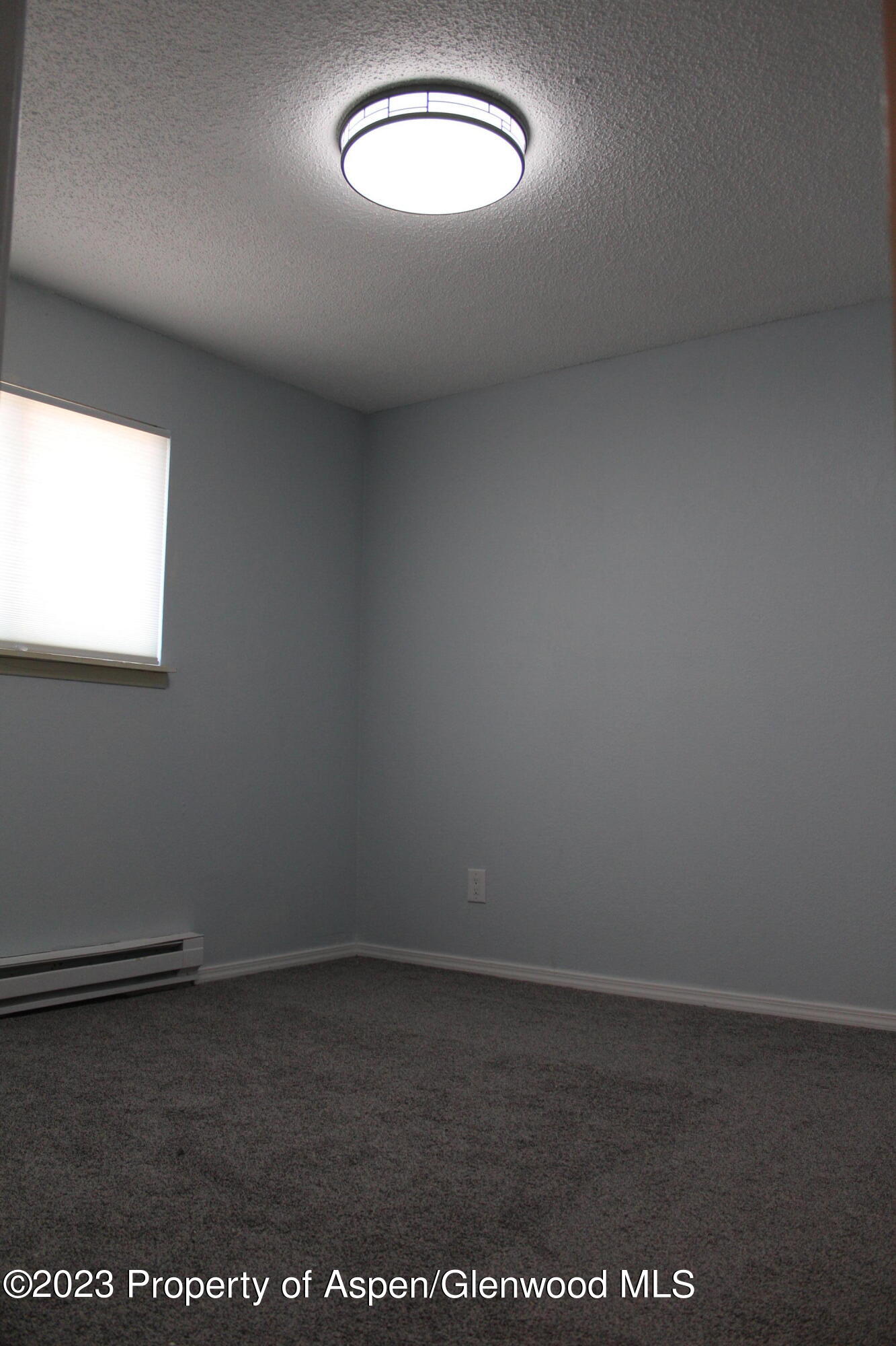 1322 East 7th Street, Unit 3 Rifle, CO 81650 - Photo 7 of 8 an empty room with a window