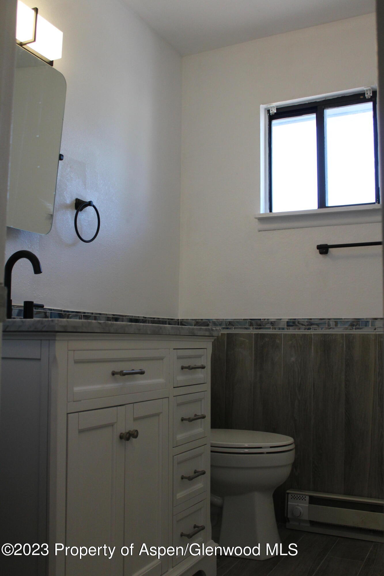 1322 East 7th Street, Unit 3 Rifle, CO 81650 - Photo 8 of 8 a bathroom with a toilet a sink and mirror