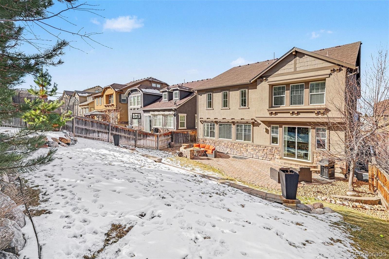 10869 Valleybrook Circle Highlands Ranch, CO 80130 - Photo 11 of 46 a view of a white house with a yard and sitting area