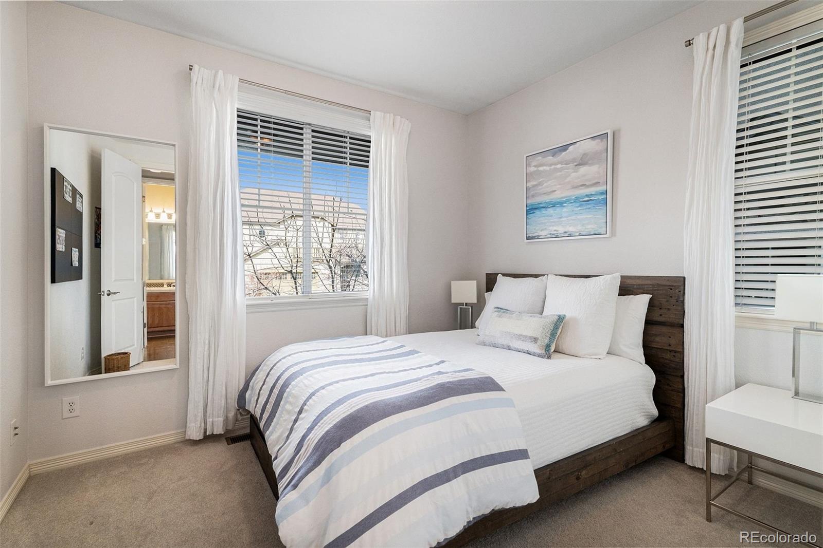 10869 Valleybrook Circle Highlands Ranch, CO 80130 - Photo 14 of 46 a bedroom with a bed and a large window