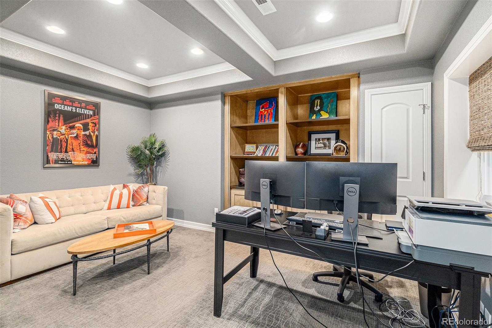 10869 Valleybrook Circle Highlands Ranch, CO 80130 - Photo 19 of 46 a living room with furniture a rug and a bookshelf