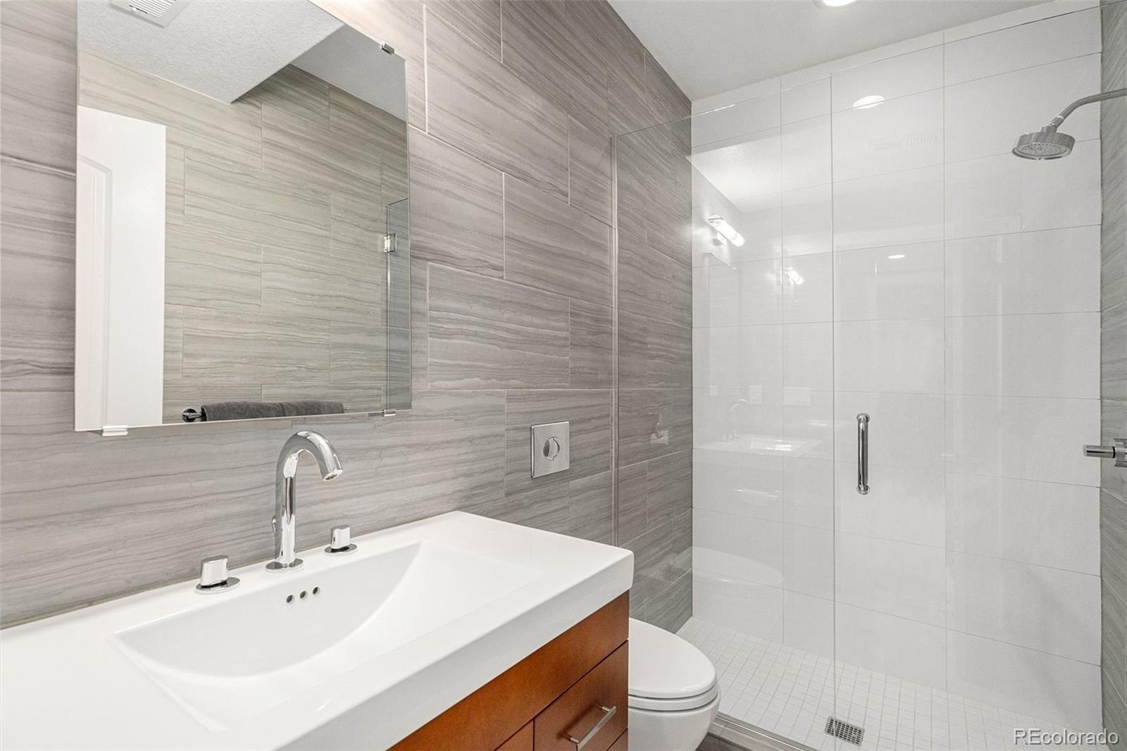 10869 Valleybrook Circle Highlands Ranch, CO 80130 - Photo 20 of 46 a bathroom with a sink a toilet and shower