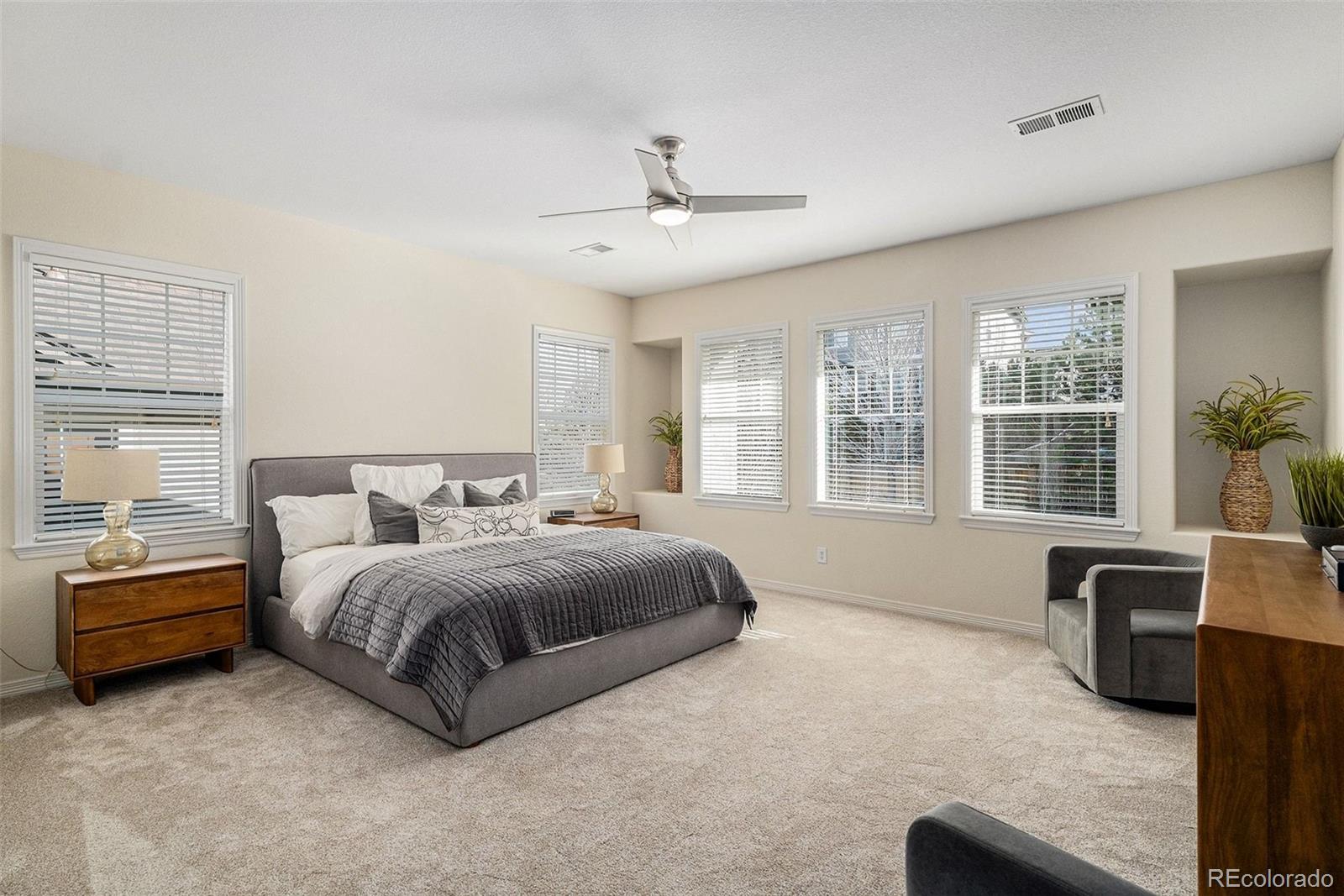 10869 Valleybrook Circle Highlands Ranch, CO 80130 - Photo 23 of 46 a spacious bedroom with a bed and glass door