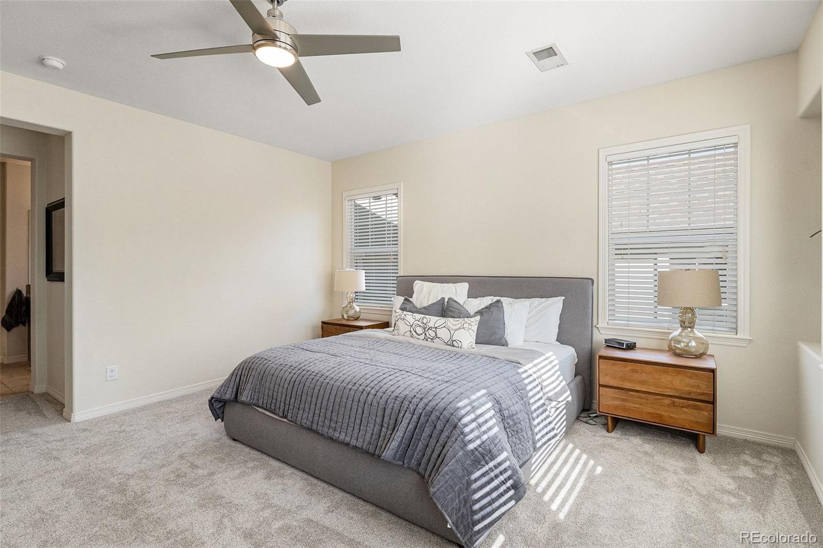 10869 Valleybrook Circle Highlands Ranch, CO 80130 - Photo 24 of 46 a bedroom with a bed and a chandelier fan