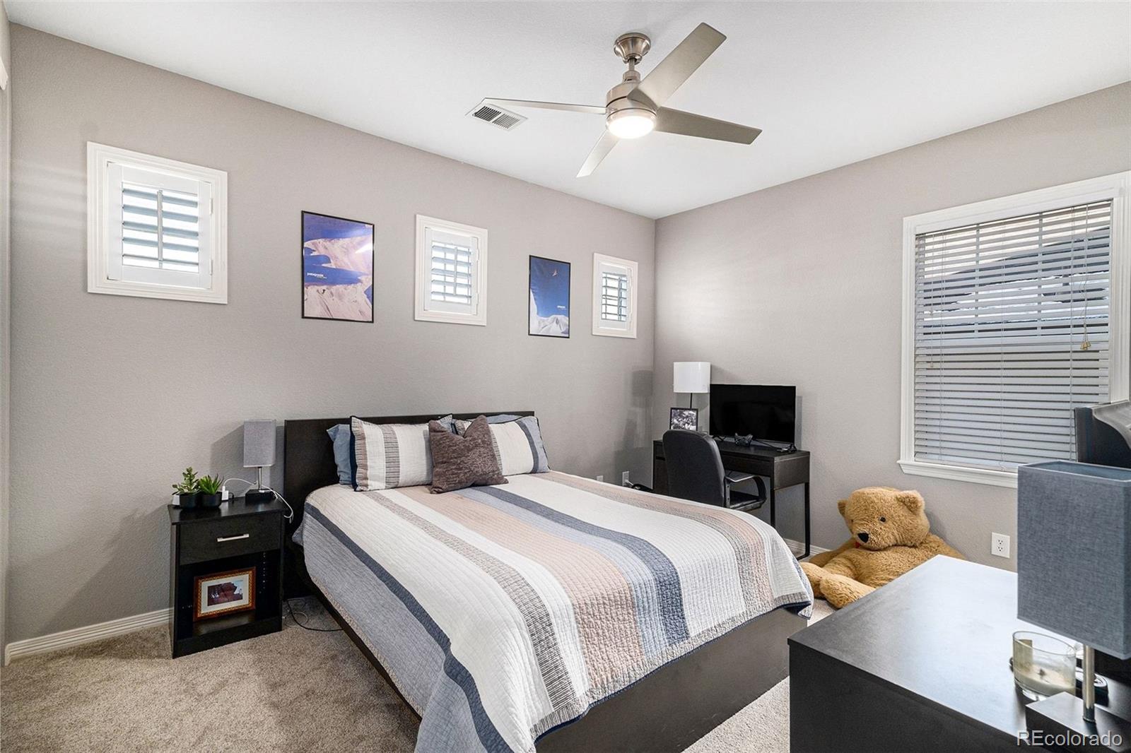 10869 Valleybrook Circle Highlands Ranch, CO 80130 - Photo 32 of 46 a bedroom with a bed and a desk