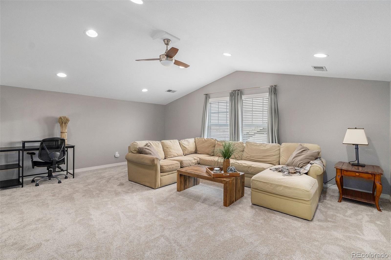 10869 Valleybrook Circle Highlands Ranch, CO 80130 - Photo 35 of 46 a living room with furniture and a lamp