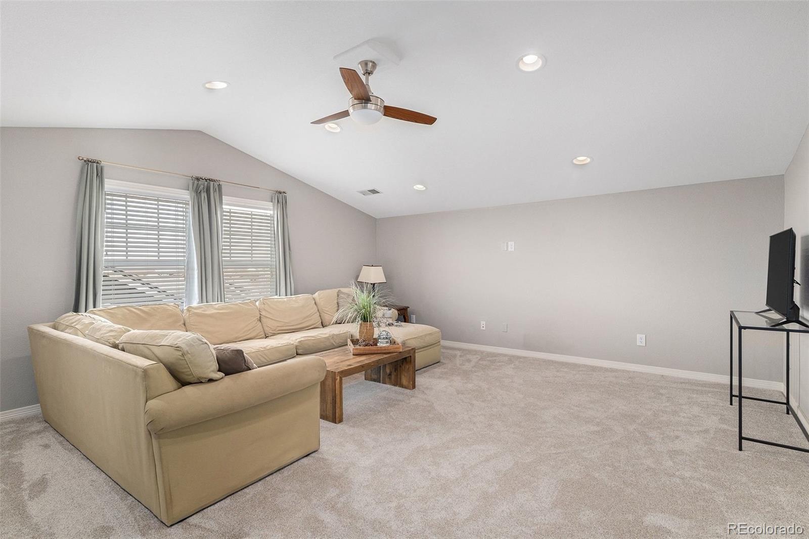 10869 Valleybrook Circle Highlands Ranch, CO 80130 - Photo 36 of 46 a living room with furniture and a large window