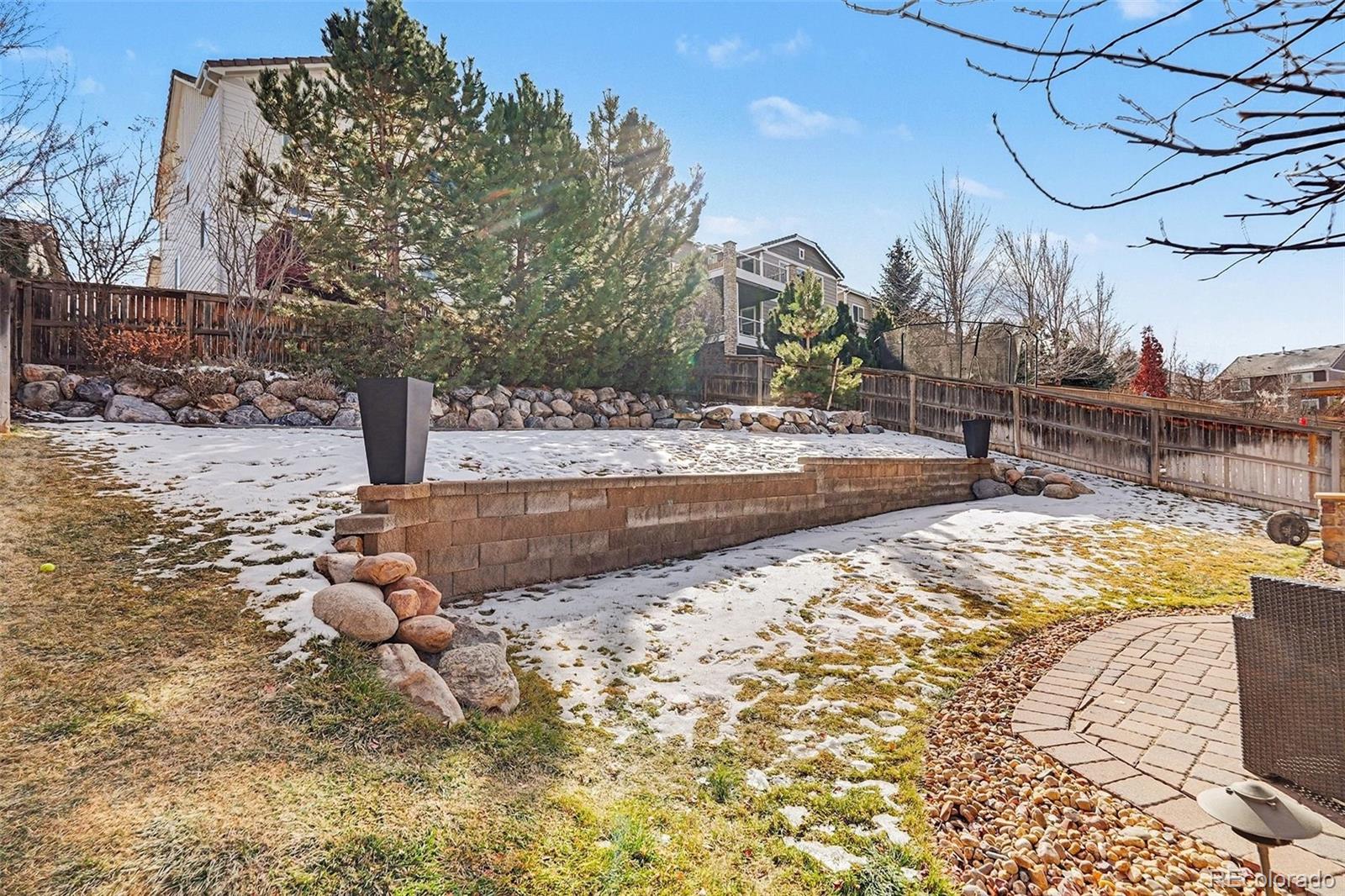 10869 Valleybrook Circle Highlands Ranch, CO 80130 - Photo 40 of 46 a view of a yard with a tree