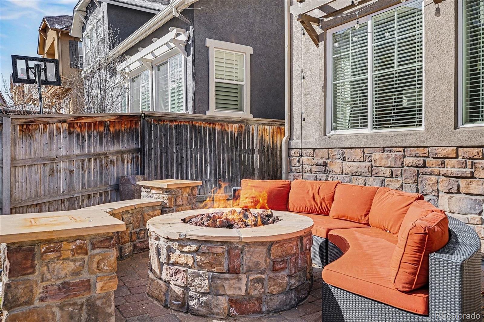 10869 Valleybrook Circle Highlands Ranch, CO 80130 - Photo 41 of 46 a outdoor space with patio couches and a fireplace