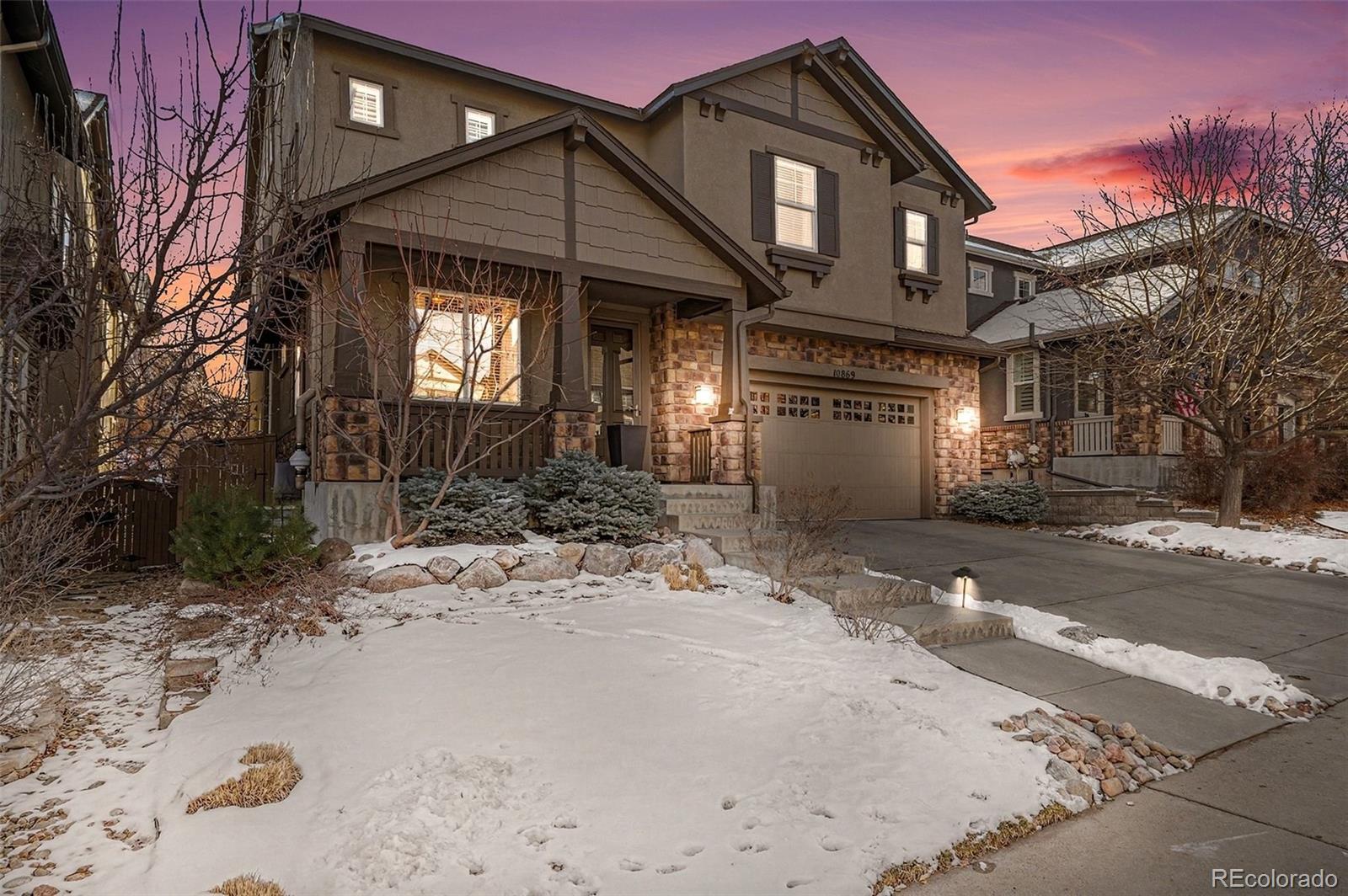 10869 Valleybrook Circle Highlands Ranch, CO 80130 - Photo 42 of 46 a front view of a house with a yard