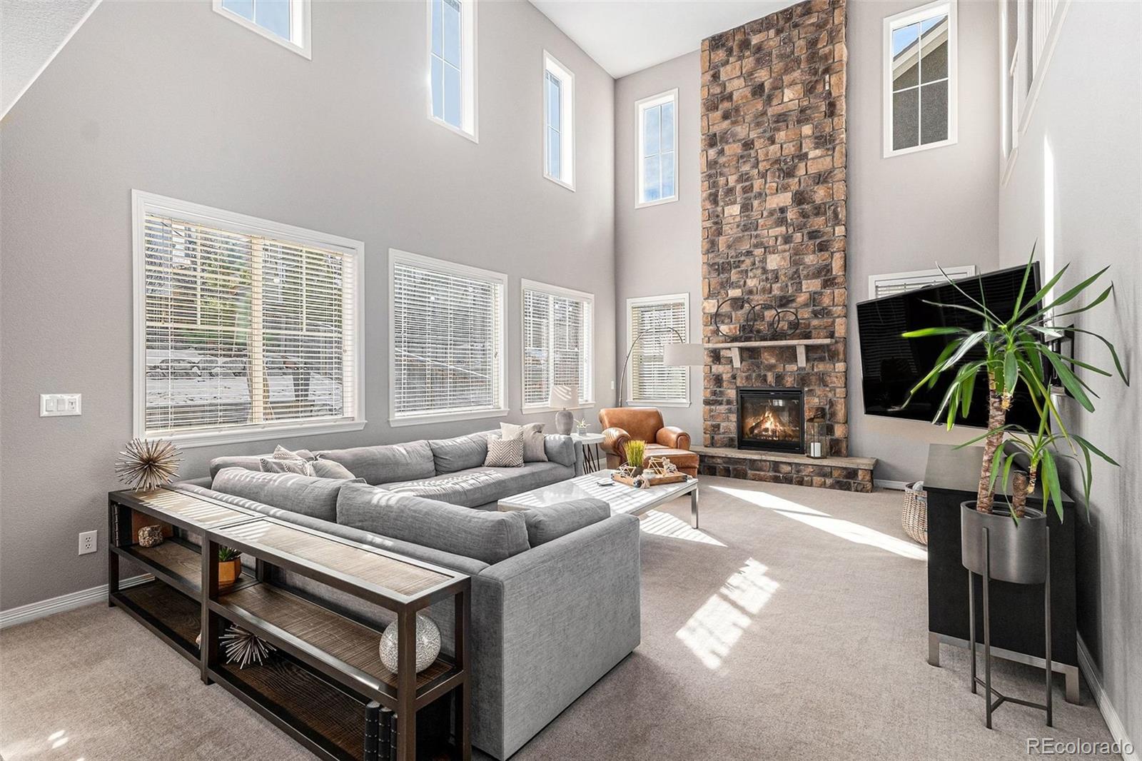 10869 Valleybrook Circle Highlands Ranch, CO 80130 - Photo 5 of 46 a living room with furniture and a large window