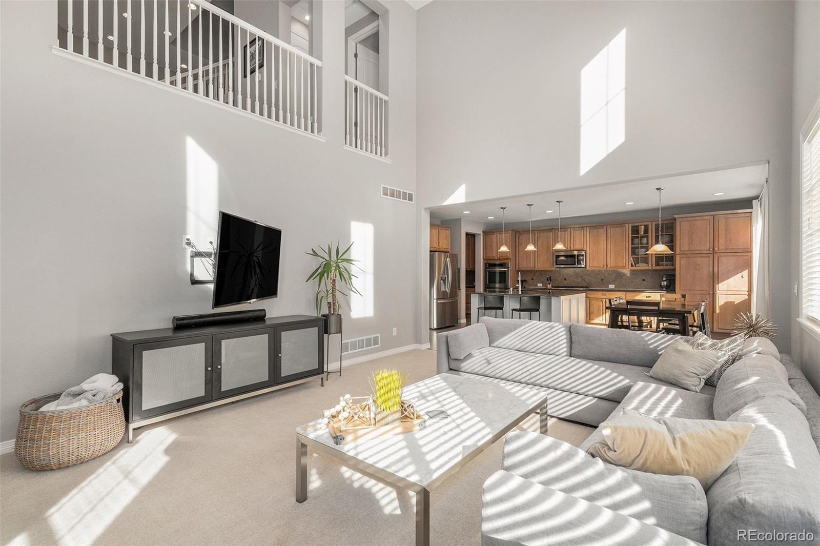 10869 Valleybrook Circle Highlands Ranch, CO 80130 - Photo 6 of 46 a living room with furniture and a flat screen tv