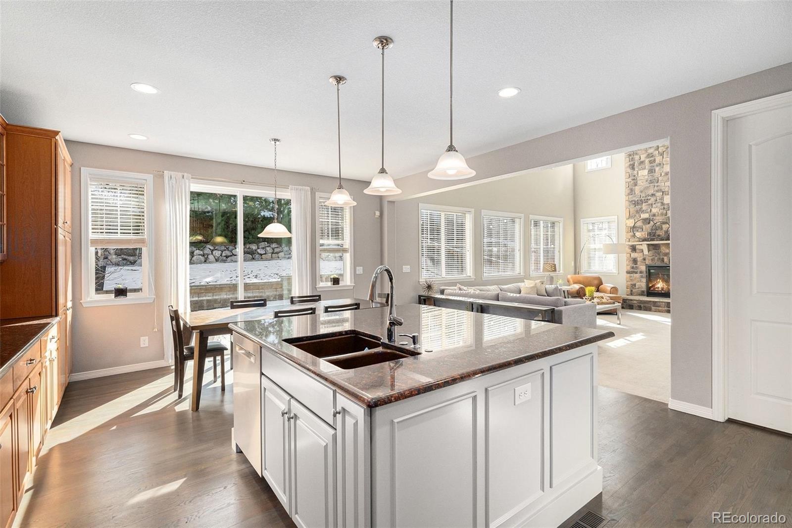 10869 Valleybrook Circle Highlands Ranch, CO 80130 - Photo 9 of 46 a kitchen with granite countertop a sink and stove