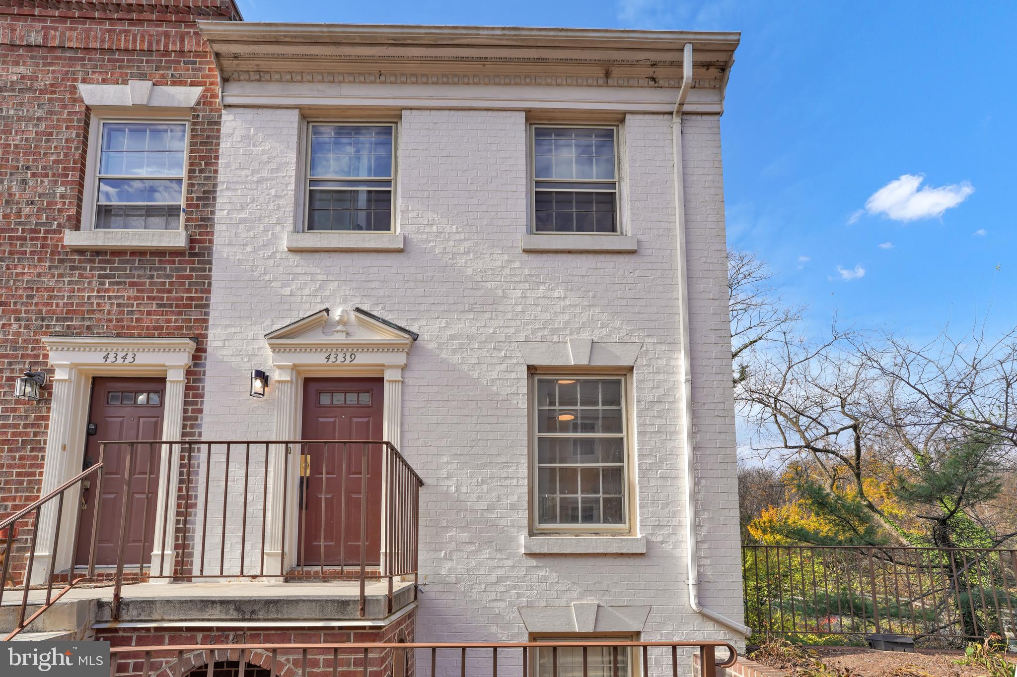 4339 Massachusetts Avenue Northwest, Unit 4339 Washington, DC 20016 - Photo 1 of 25 a front view of a house with a yard