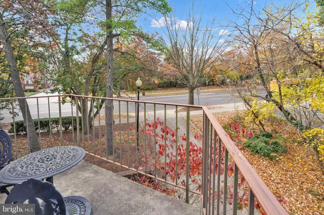a view of balcony with wooden floor and fence