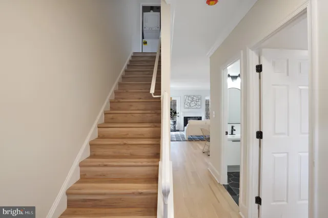 a view of a hallway with wooden floor and entryway