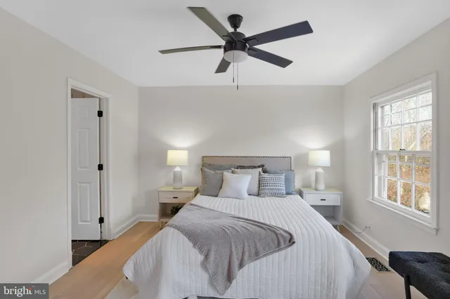 a bedroom with a bed and a large window
