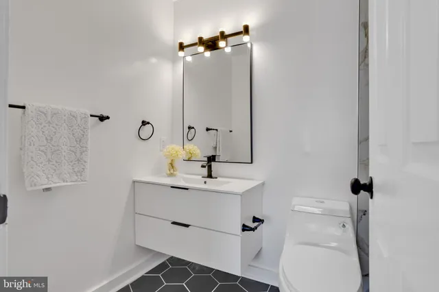 a bathroom with a sink toilet and mirror