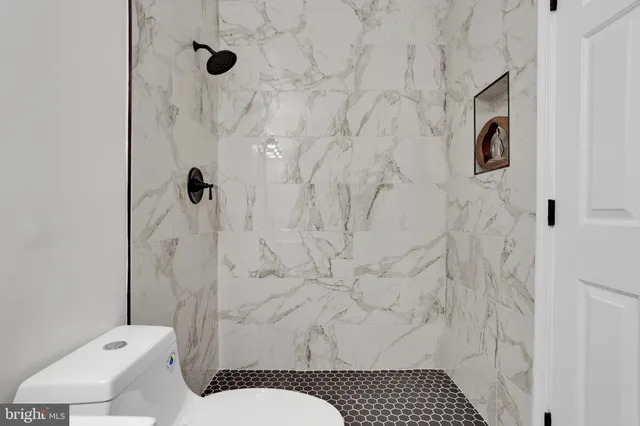a bathroom with a toilet sink and shower