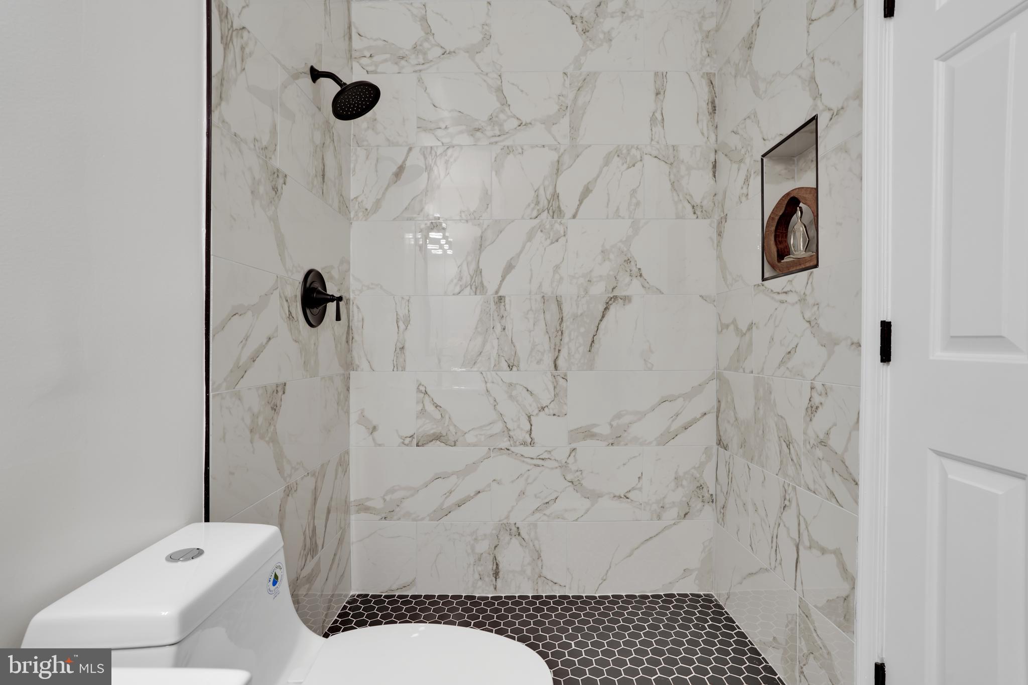 4339 Massachusetts Avenue Northwest, Unit 4339 Washington, DC 20016 - Photo 19 of 25 a bathroom with a toilet sink and shower